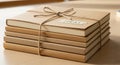 A stack of five brown notebooks tied with a simple twine bow sits on a wooden table. Each notebook Royalty Free Stock Photo