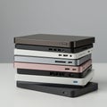 A stack of five external hard drives in various colors, including black, white, silver, pink Royalty Free Stock Photo