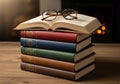 A stack of five hardcover books with different colored spinesâred, blue, green, and Royalty Free Stock Photo