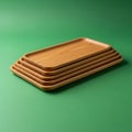 A stack of five rectangular wooden trays rests on a green surface Royalty Free Stock Photo