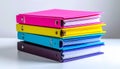 Stack of five colorful ring binders with white papers on white surface Royalty Free Stock Photo