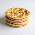 A stack of five round, flatbreads is arranged on a white surface Royalty Free Stock Photo