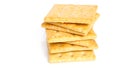 A stack of five square, golden-brown crackers with small holes arranged in a grid pattern. Royalty Free Stock Photo