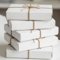 A stack of five white rectangular boxes tied individually with simple brown twine, Royalty Free Stock Photo
