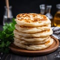 a stack of flat bread on a wooden plate