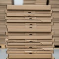 Stack of flat, rectangular cardboard boxes, possibly used for packaging or shipping. Royalty Free Stock Photo