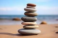 a stack of flat, round stones balanced on a sandy beach