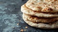 A close-up image of a stack of freshly baked flatbreads against a textured dark background Royalty Free Stock Photo
