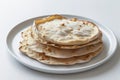 Stack of flatbreads on a white plate with a light background food photography studio shot Royalty Free Stock Photo