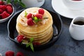 Stack of fluffy buttermilk pancakes with raspberry and coconut