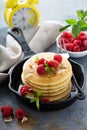 Stack of fluffy buttermilk pancakes with raspberry and coconut