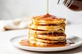 stack of fluffy pancakes with a drizzle of syrup