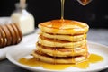 stack of fluffy pancakes with a drizzle of syrup