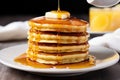 stack of fluffy pancakes with a drizzle of syrup