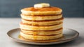 A stack of fluffy pancakes sits on a ceramic plate Royalty Free Stock Photo