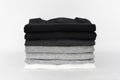 Stack of folded black, grey and white color monochrome t-shirt on white background Royalty Free Stock Photo