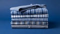 Stack of folded blue and white checkered shirts Royalty Free Stock Photo