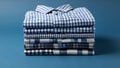 Stack of folded blue and white checkered shirts Royalty Free Stock Photo