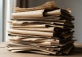 A stack of folded brown cardboard sheets on a wooden surface. Royalty Free Stock Photo