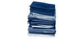 Stack of folded clean blue bedding on a white background: duvet covers, sheets, pillowcases. Close-up. Copy space Royalty Free Stock Photo