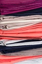 Stack of folded clean colored linens: duvet covers, sheets, pillowcases. The concept of housework and storage. Closeup Royalty Free Stock Photo