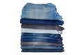 Stack of folded clothes, blue jeans pants, dark blue denim trousers isolated on white. Royalty Free Stock Photo