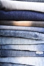 Stack of folded clothes, blue jeans pants, dark blue denim trousers on white background Royalty Free Stock Photo