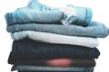 Stack of folded clothes, blue jeans pants, dark blue denim trousers on white background Royalty Free Stock Photo