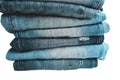 Stack of folded clothes, blue jeans pants, dark blue denim trousers on white background Royalty Free Stock Photo