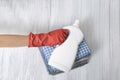 Stack of folded clothes and detergent bottle in female hand. Housework Royalty Free Stock Photo