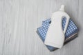 Stack of folded clothes and detergent bottle. Top view Royalty Free Stock Photo
