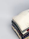 Stack of Folded Clothes on a Plain Background for Laundry or Fashion Royalty Free Stock Photo