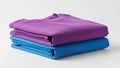 Stack of folded clothes in purple and blue isolated on white background Royalty Free Stock Photo