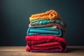a stack of folded clothes on a wooden table with a dark background photo by scott scott scott scott scott scott scott scott scott Royalty Free Stock Photo