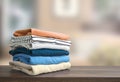 Stack of folded clothing, autumn colors stacked sweaters.Heap of clothes.Laundry,household