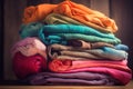 a stack of folded cloths on a wooden table with a wooden background and a wooden wall in the backround of the photo Royalty Free Stock Photo