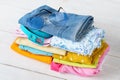 Stack of folded colorful clothes. Modern casual clothing.
