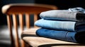 Stack of folded denim jeans in a gradient on wooden surface Royalty Free Stock Photo