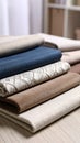 Stack of folded fabric swatches in neutral and blue tones with textured and patterned surfaces Royalty Free Stock Photo