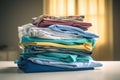 stack of folded hospital gowns on a sterile surface