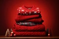 Stack of folded knitted red Christmas turtleneck sweaters or pullovers on red background Royalty Free Stock Photo