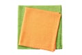 Stack of folded orange and pale green napkins on white