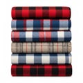 A stack of folded plaid blankets in various colors isolated on white background Royalty Free Stock Photo