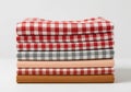 Stack of folded plaid fabric squares in various red white and gray tones with white border Royalty Free Stock Photo