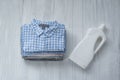 Stack of folded shirts and detergent bottle. Top view Royalty Free Stock Photo