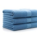 Stack of folded soft blue towels neatly arranged on a white surface Royalty Free Stock Photo
