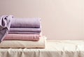 Stack of folded tablecloths in soft pastel colors on a neutral background Royalty Free Stock Photo