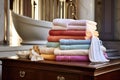 stack of folded towels beside an elegant bathtub