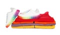 Stack of folded warm clothes and sport shoes on white background Royalty Free Stock Photo