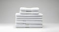 Stack of folded white towels on a white surface against a light gray background Royalty Free Stock Photo
